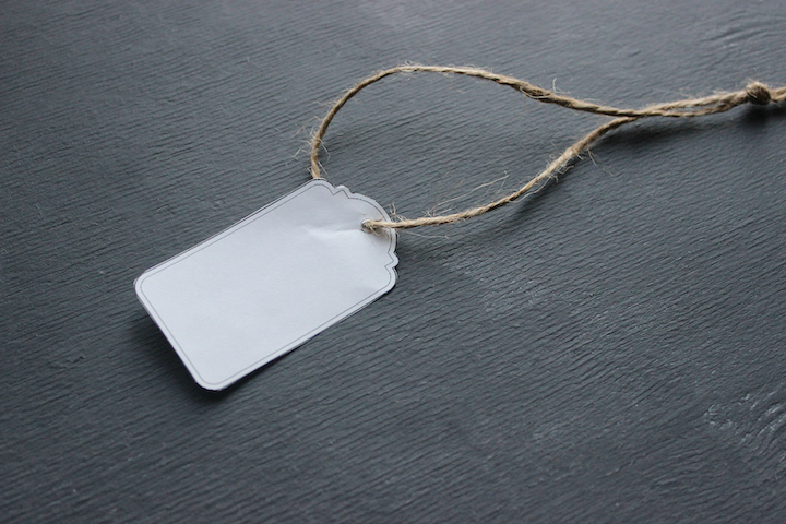 Blank Price Tag, White Tag Against The Black Wood.  An Empty Tag Is Associated. Price Tag, Gift Tag,